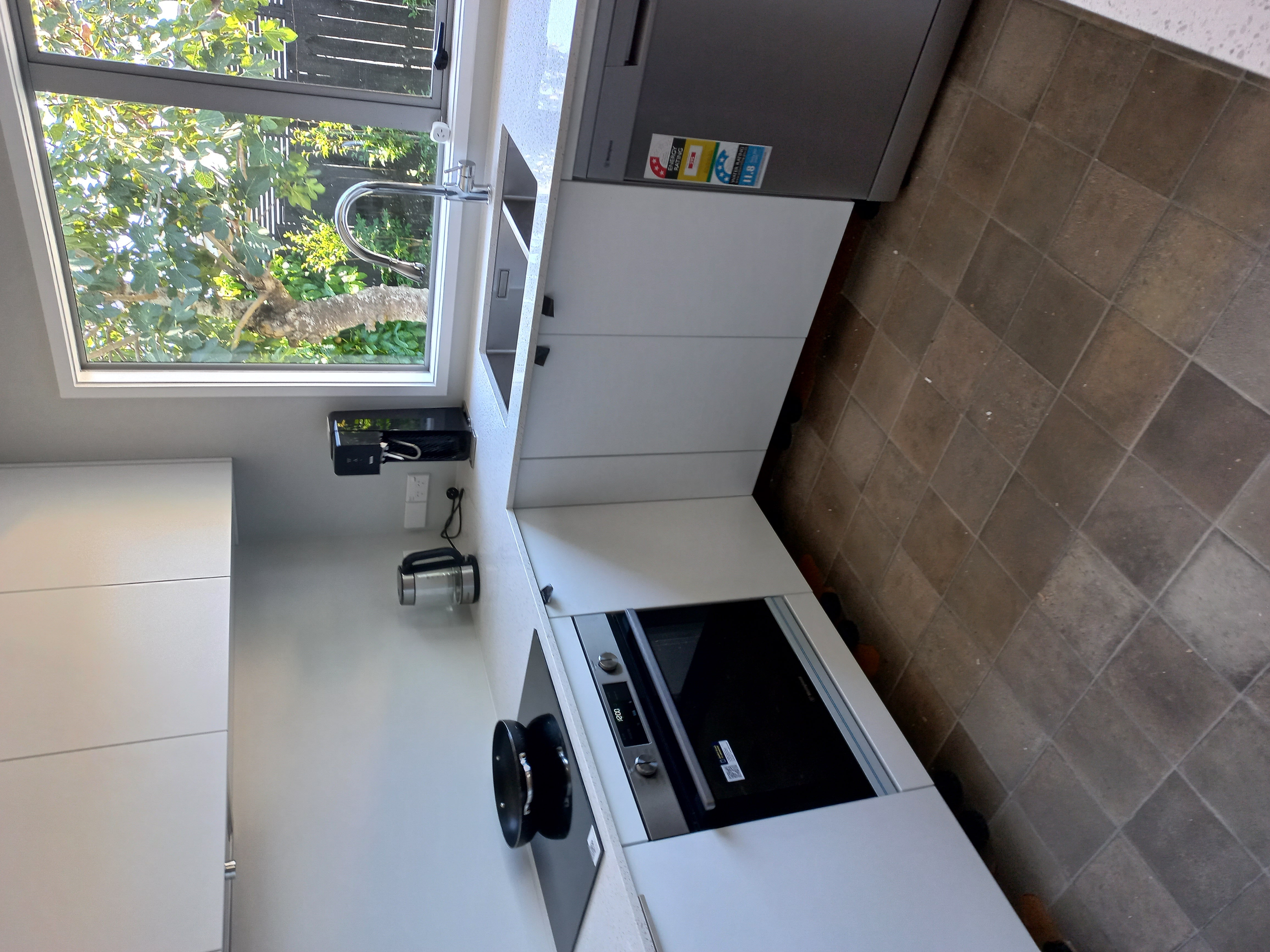 A newly renovated kitchen with modern appliances and task lighting